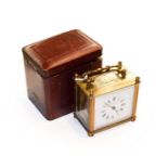 A brass carriage timepiece with fitted travelling case