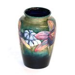 A Walter Moorcroft Orchid and spring flower vase, impressed factory marks, paper label and painted