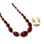 A pair of shell drop earrings, length 3.3cm; a shell brooch, length 2.8cm; and a red amber bead
