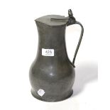 An 18th century pewter jug, with twin acorn thumb piece