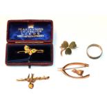 A 9 carat gold swallow bar brooch, length 4.2cm; a 9 carat gold shamrock brooch; a butterfly brooch,