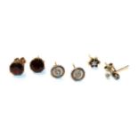 A pair of garnet solitaire earrings, stamped '9CT'; a pair of diamond solitaire earrings,