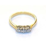 An 18 carat gold diamond three stone ring, finger size O . Gross weight 3.0 grams.