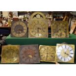~ Seven 18th century longcase clock dials and movements, comprising, an eight day brass dial
