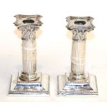 A pair of Edward VII silver candlesticks, by Hawksworth, Eyre and Co. Ltd., Sheffield, 1905, each on