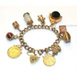 A charm bracelet, stamped '9' and '.375', hung with ten charms including a teddy bear, a barrel,