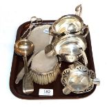 A selection of silver items including, a dressing table hand mirror and brush, sauce ladles,