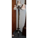 A wrought iron three branched standard lamp converted to electric and a gilt bezel, another gilt