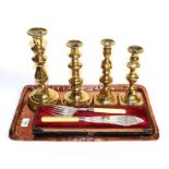 A cased pair of silver fish servers, two pairs of candlesticks and a copper tray