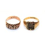 An 18 carat gold mourning ring, finger size R; and a rope work ring, stamped '9CT', finger size R (