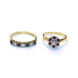 An 18 carat gold sapphire and diamond seven stone ring, finger size Q; and an 18 carat gold ruby and