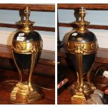 A pair of modern parcel gilt table lamps, swag detail, tripod supports to trefoil bases, from