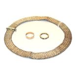 A 9 carat gold band ring, finger size S; an Indian white metal choker; and a paste set eternity ring