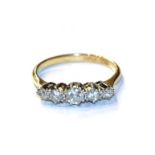 A diamond five stone ring, stamped '18CT' and 'PLAT', finger size M1/2. Gross weight 2.5 grams.