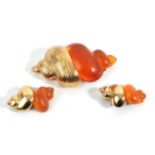 A Brooch, by Christian Dior, stylised in the form of a shell with orange plastic and gilt metal