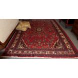 Hamadan carpet, the deep raspberry field centred by an indigo medallion framed by ivory borders,