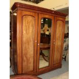 A Victorian mahogany mirrored triple wardrobe