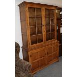 A well made Georgian style oak glazed and panelled bookcase