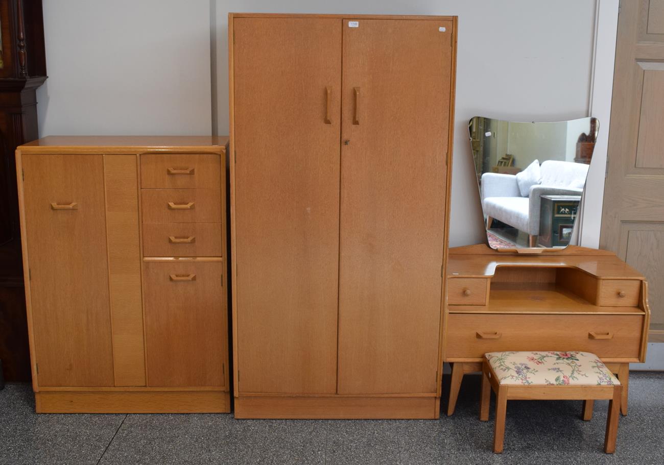 A 1960's G-Plan oak veneered three-piece bedroom suite, a similar stool and a single dining chair