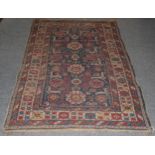 Kuba rug, the mid indigo field of stylised flowerheads enclosed by Harshang borders, 186cm by 120cm
