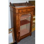 A Victorian figured walnut pier cabinet with a three-quarter gallery