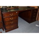 A 20th century mahogany and leather top partners desk in the Georgian style