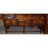 A 17th century style oak dresser with geometric moulded drawers