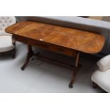 A reproduction mahogany and crossbanded sofa table in the Regency style