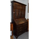 A carved oak bureau bookcase