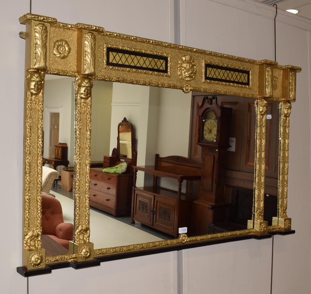 A gilt framed sectional over mantel mirror