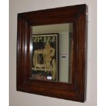 An oak framed mirror of square form