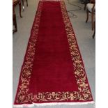 Tabriz runner, signed, the plain field enclosed by floral vine borders, 420cm by 86cm