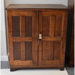 An oak double door cabinet enclosing eight trays, 112cm wide