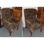 A pair of 1920's mahogany framed wing back armchairs
