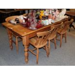 A pine farmhouse kitchen table with six matching chairs