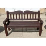 A stained hardwood garden bench