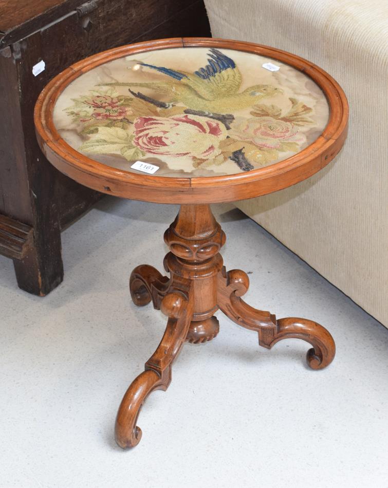 A Victorian mahogany circular tripod table with wool work panel, together with a 19th century