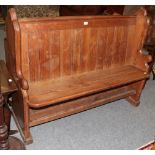 A Victorian pitch pine pew, 135cm wide