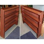 A pair of stained pine four-tier waterfall bookcases