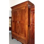 An 18th century French armoire with cupboard doors enclosing hanging space, with a deep drawer to