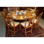 George III style circular oak dining table raised on a substantial pedestal issuing four downswept