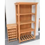 A modern oak free standing bookcase and bottle rack
