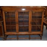 An early 20th century oak cabinet with presentation plaque 'To Reverend JHP Welby'