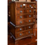 A miniature reproduction mahogany chest on chest