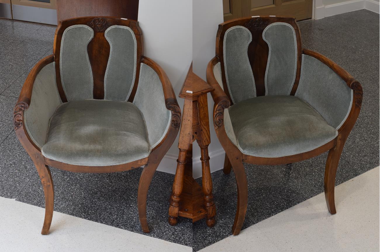 A pair of Art Deco walnut tub shaped armchairs