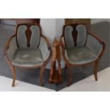 A pair of Art Deco walnut tub shaped armchairs