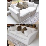 A modern cream three-seater sofa, and matching two-seater sofa with scatter cushions, retailed by