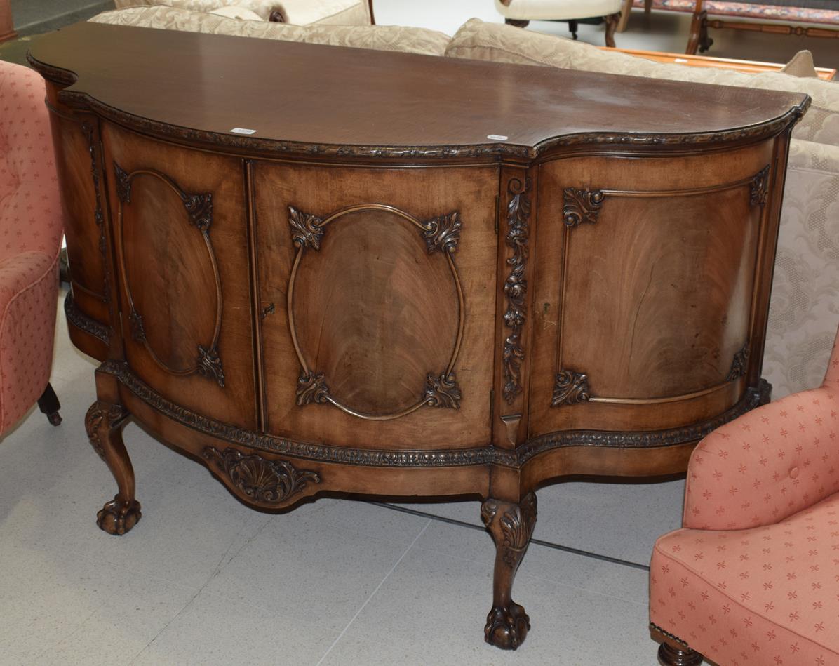 A carved mahogany serpentine fronted sideboard