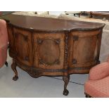 A carved mahogany serpentine fronted sideboard