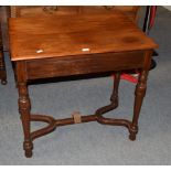 A mahogany side table on turned legs and a shaped stretcher